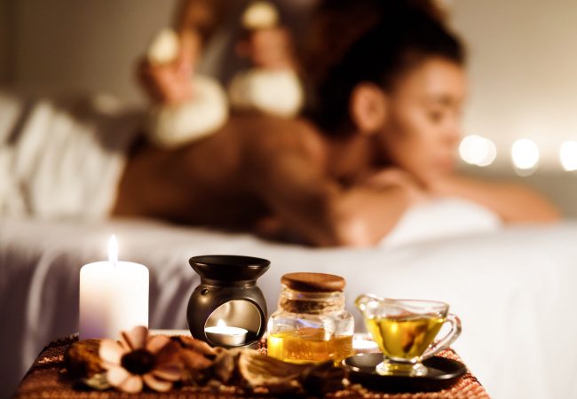 Aroma spa. Girl getting thai herbal compress massage and enjoying aromatherapy